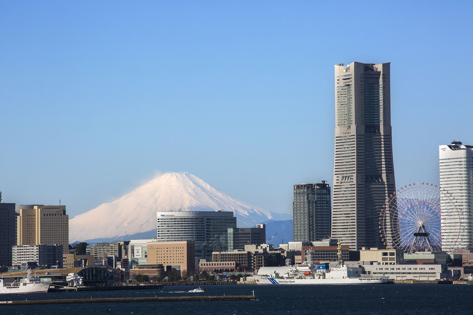 A snow-capped Mount Fuji glimpsed from off the Yokohama coast, from a ferry plying Tokyo Bay.
